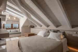 a bedroom with a large bed with white pillows at Casa Della Vita Gouves Cretan Luxury Villa in Gournes +82 photos