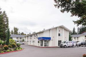 um grande edifício branco com estacionamento em Motel 6-Seattle, WA - Sea-Tac Airport South em SeaTac