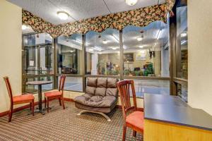 a waiting room with a chair and a table at Days Inn by Wyndham Hernando in Hernando