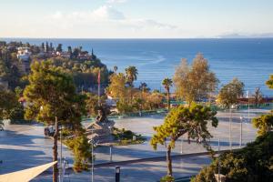 a view of a park with the ocean in the background at Mavi Avlu - Main Square Old Town in Antalya