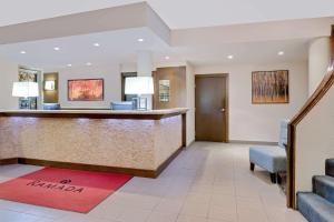 a lobby of a hotel with a reception desk at Ramada by Wyndham Kamloops in Kamloops