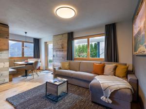 a living room with a couch and a table at Van's Place, Luxury Apartment in Kaltenbach