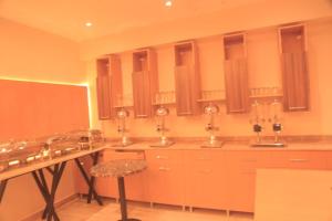 a kitchen with three sinks and a stool at Lego Star Hotel in Addis Ababa +18 photos