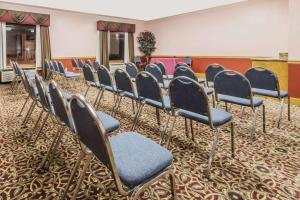 a row of chairs in a waiting room at Super 8 by Wyndham Fort Worth Downtown South in Fort Worth