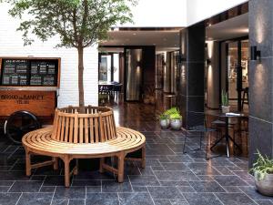 a wooden bench sitting in front of a restaurant at INK Hotel Amsterdam - MGallery in Amsterdam