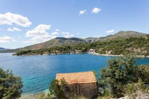 a view of a body of water with a house at Holiday Home Magazin in Slano