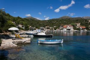 three boats are docked in a body of water at Holiday Home Magazin in Slano
