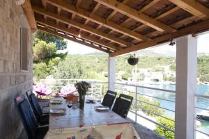 a table on a patio with a view of the water at Holiday Home Magazin in Slano