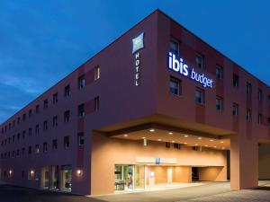 a building with a sign on the side of it at ibis budget Zurich Airport in Glattbrugg