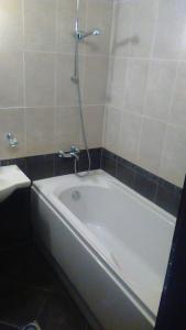 a white bath tub in a bathroom with a shower at Aspen Heights 4 bed studio in Bansko