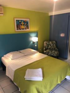 En eller flere senge i et værelse på Coco-Mango Apt B