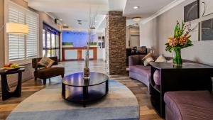 a living room with a couch and a table at Best Western PLUS Avita Suites in Torrance