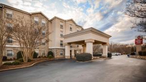 a large apartment building with a parking lot at Best Western Plus Greenville South in Piedmont