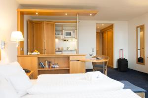 a hotel room with two beds and a table at Strandhotel Juister Hof in Juist +15 photos