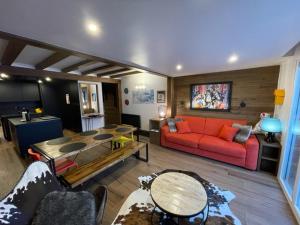 a living room with a red couch and a table at Immodelpas Pic Blanc in Pas de la Casa