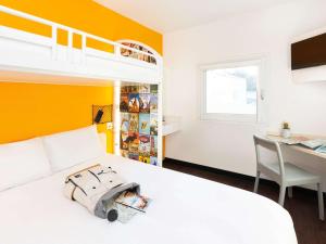 a bedroom with a bed with a toy car on it at hotelF1 Rouen Louviers Val de Reuil in Val de Reuil