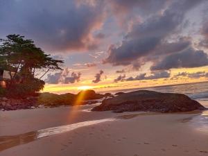a sunset on a beach with a rainbow at Phuket Green Home in Karon Beach +18 photos