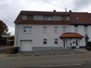 a white house with a red roof at Apartment da Luiz Salvatore in Wurmlingen