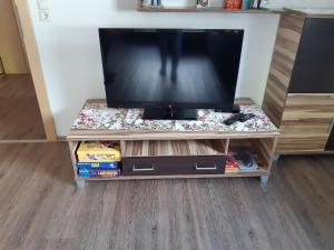 a flat screen tv on a wooden entertainment center at Gertis Appartment Top 1 in Stumm