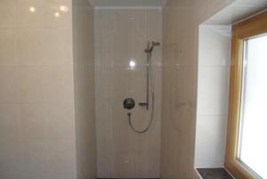 a shower stall in a bathroom with a glass door at Gertis Appartment Top 2 in Stumm
