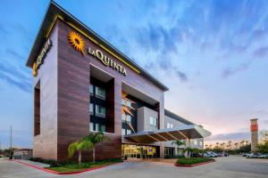 un edificio de hotel con una señal de sol en él en La Quinta by Wyndham McAllen Convention Center, en McAllen