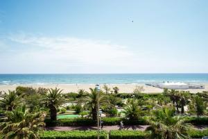 a view of the beach from the balcony of a resort at Best Western Plus Hotel Canet-Plage in Canet-en-Roussillon