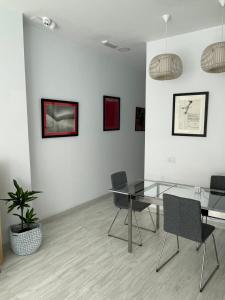 拉斯帕爾馬斯的住宿－Coworking Studio，一间设有玻璃桌和椅子的用餐室