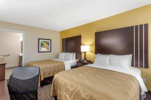 a hotel room with two beds and a desk at Quality Inn Seneca US-123 in Seneca