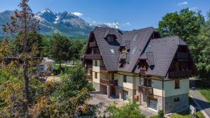 an aerial view of a house with mountains in the background at TATRYSTAY Julia Apartments in Tatranská Lomnica