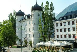 a large white building with domes on top of it at City Zimmer - Appartement Dina Mariner in Lienz