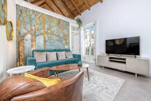 A television and/or entertainment centre at Mira Apartment in Malaga by Solaga Holiday Homes