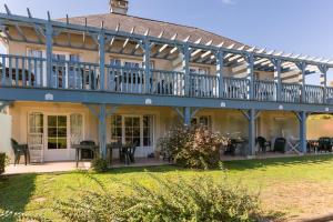 a large house with a large deck and patio at Résidence Les Belles Rives - maeva Home in Argentat