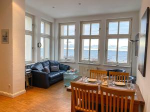 a living room with a table and a couch at Villa Anna Meerblick erste Reihe in Ahlbeck