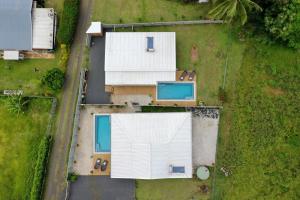 an overhead view of a house with a white roof at Te Etu Villa 1 in Rarotonga