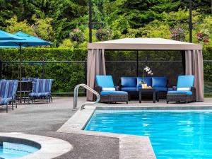 a living room filled with furniture and a pool at Fairmont Chateau Whistler in Whistler