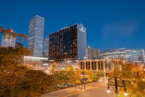 a city skyline at night with tall buildings at Sonesta Denver Downtown in Denver +56 photos
