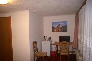 Zimmer mit einem Tisch und einem Esszimmer in der Unterkunft Pension Zur Sonne in Mansfeld