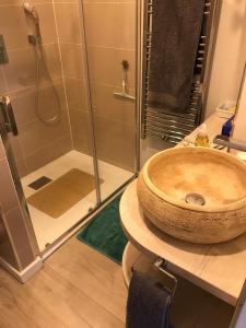 a bathroom with a wooden sink and a shower at La Villa Soregia in Lattes