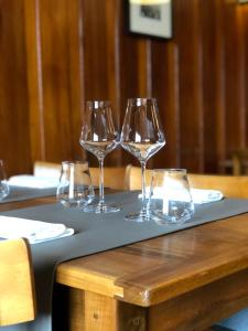four wine glasses sitting on top of a table at Café Cher-Mignon et Chambres d'hôtes in Chermignon-dʼen Haut
