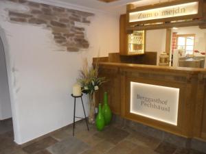 a restaurant with a counter with a sign on the wall at Berggasthof Pechhäusl in Berchtesgaden