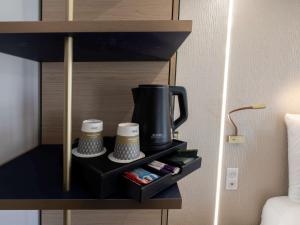 a coffee maker on a shelf in a hotel room at Mercure Paris Opera Lafayette in Paris