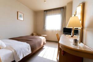 Postel nebo postele na pokoji v ubytování Oyama Palace Hotel