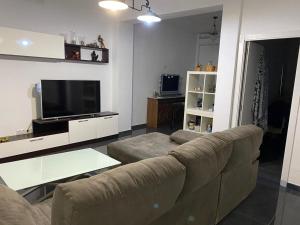 A television and/or entertainment centre at CASA REFORMADA CON TERRAZA/WIFI/AIRE ACONDICIONADO