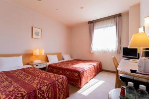 Postel nebo postele na pokoji v ubytování Oyama Palace Hotel + 22 fotografií