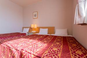 Postel nebo postele na pokoji v ubytování Oyama Palace Hotel