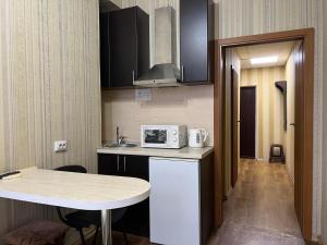 a small kitchen with a counter and a microwave at The apartments in Kyiv
