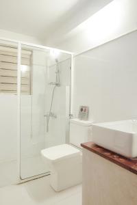 a bathroom with a shower and a toilet and a sink at Gruhaya Boutique Villa in Kandy +96 photos
