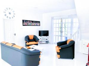 a living room with two couches and a tv at Bandarawela luxurious villa in Bandarawela
