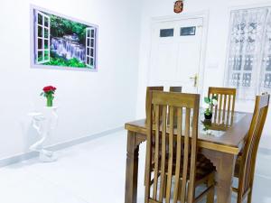 a dining room with a wooden table and chairs at Bandarawela luxurious villa in Bandarawela