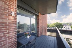 A balcony or terrace at Modern Studios and Apartments at Barking Wharf in London